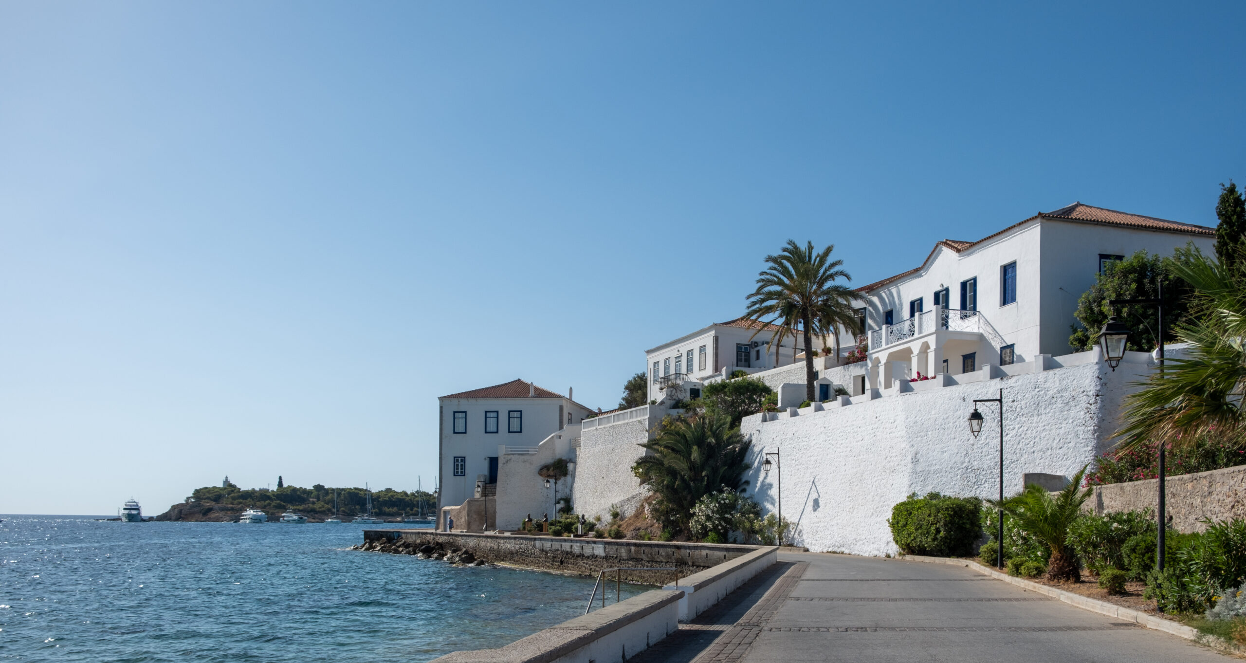 Spetses island, Greece. Seafront neoclassical buildings, old historic town, sunny summer day